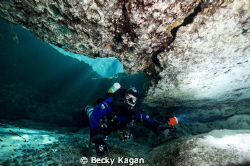 My dive buddy poking his head into a cave in FL with sunr... by Becky Kagan 